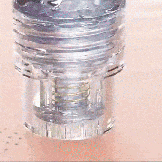 Close-up of micro-infusion tip releasing serum into skin